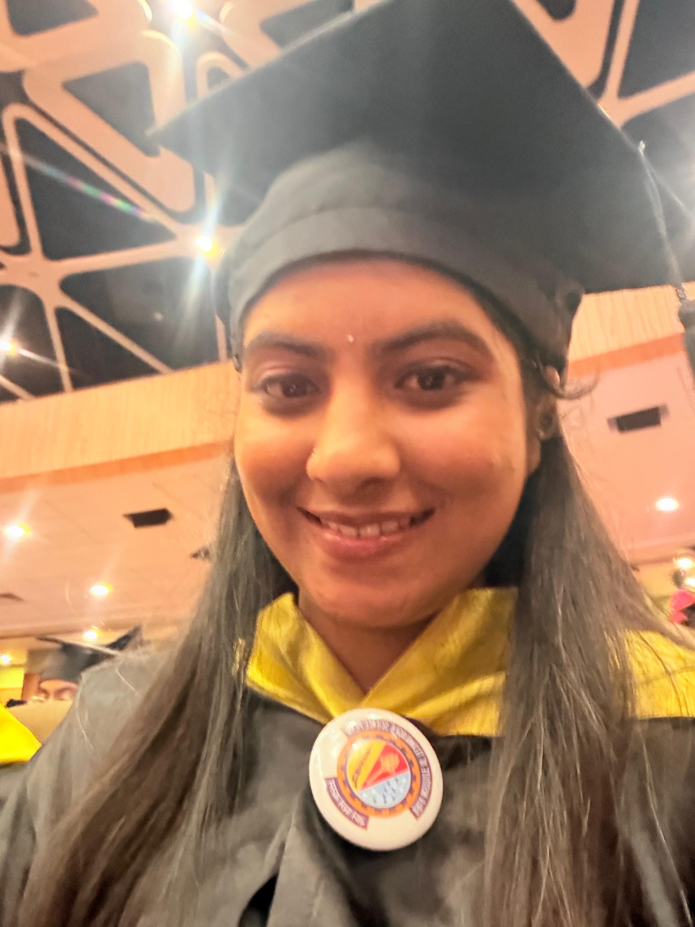 Pallavi in graduation cap and gown, smiling at the BITS Pilani convocation venue